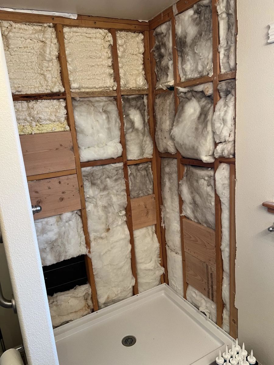 Demolished shower enclosure prepared for new wall installation